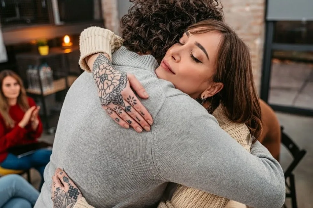 Two people embracing in a supportive moment at Nova Recovery